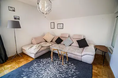 a living room with a couch and a table at Apartment Marni w/ Parking | Kranjska Gora in Kranjska Gora