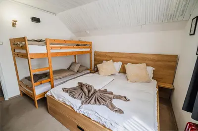 a bedroom with two bunk beds and a ladder at Apartment Marni w/ Parking | Kranjska Gora in Kranjska Gora