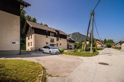 a white car parked in front of a house at Apartment Marni w/ Parking | Kranjska Gora in Kranjska Gora