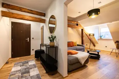 a living room with a bed and a mirror at Gris Apartment in Gornja Radgona