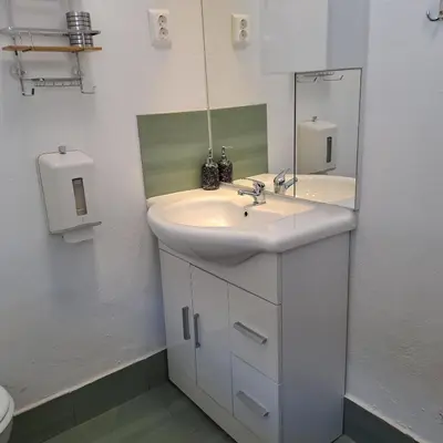 a bathroom with a white sink and a mirror at Apartma Kolpa Krasinec in Gradac