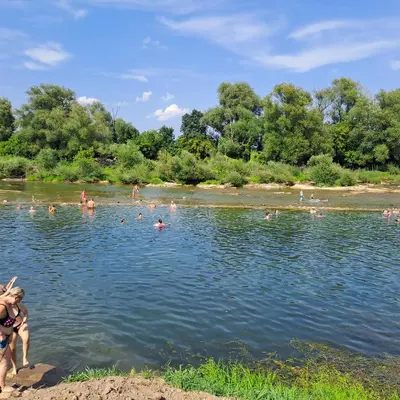 a group of people swimming in a river at Apartma Kolpa Krasinec in Gradac