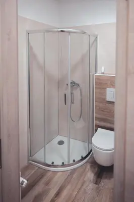 a shower stall in a bathroom with a toilet at Maribella Apartment in Maribor