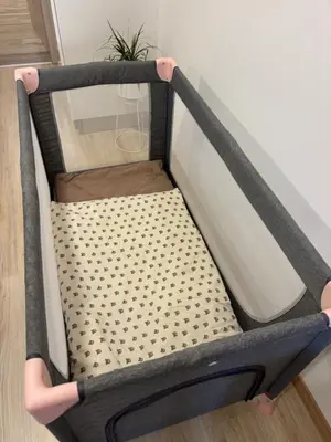 a bed frame with a cot in a room at Maribella Apartment in Maribor
