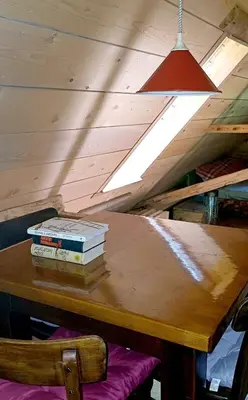 two books sitting on top of a wooden table at Loghouse cabin in the Kočevje forest in Kočevje