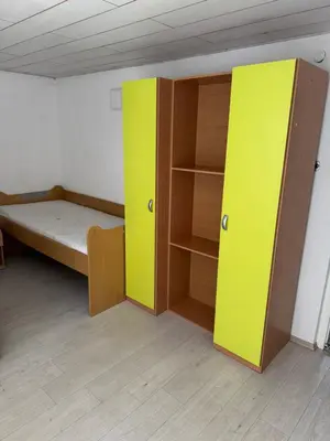 a room with a bed and a book shelf at Lipovska Oaza