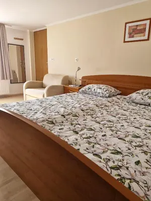 a bedroom with a bed with a flowery comforter at Apartma P&B in Bled