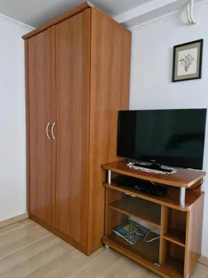 a large wooden cabinet with a television in a room at Apartma P&B in Bled