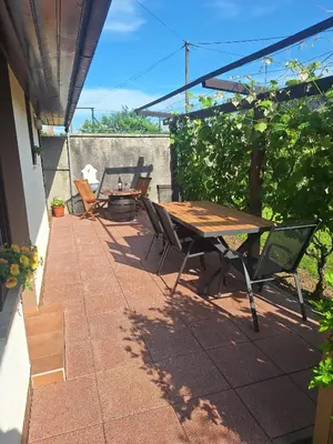 a patio with a wooden table and chairs at Apartma P&B in Bled