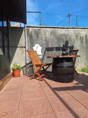 a wooden table and a bench and a table and a barrel at Apartma P&B in Bled