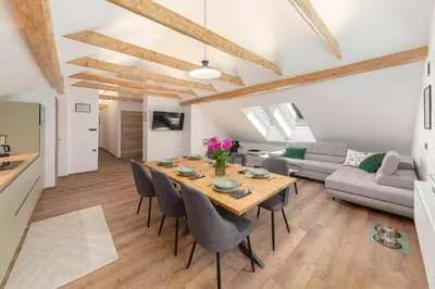 a dining room and living room with a table and chairs at Brlog 2 in Zgornje Gorje