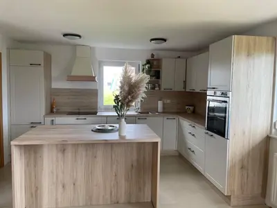 a kitchen with a island with a vase of flowers on it at Apartment9B in Krško