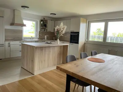 a kitchen with a wooden table and a dining room at Apartment9B in Krško