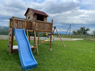 a playground with a slide and a play house at Apartment9B in Krško
