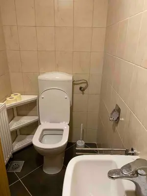 a bathroom with a toilet and a sink and a tub at Apartment9B in Krško
