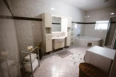 a bathroom with a tub and a sink and a bath tub at Chonky Cat in Moravske Toplice