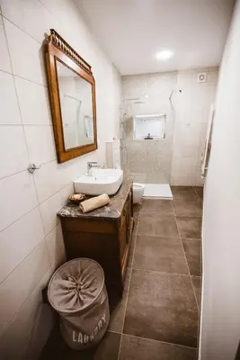 a bathroom with a sink and a mirror at Chonky Cat in Moravske Toplice