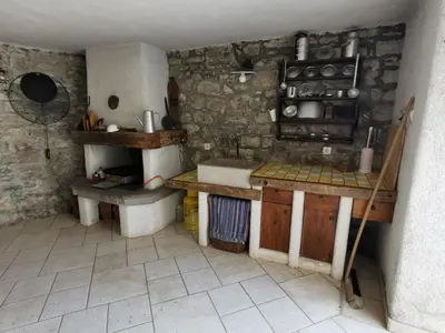 a small kitchen with a sink and a counter at Domus Carstica in Sežana