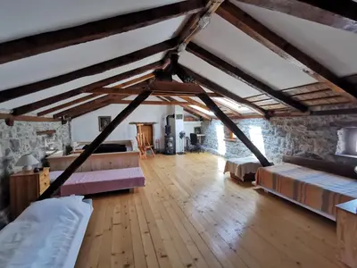 an attic room with beds and wooden floors at Domus Carstica in Sežana