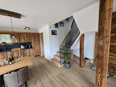 a living room with wooden floors and a staircase at Savinjski raj in Mozirje