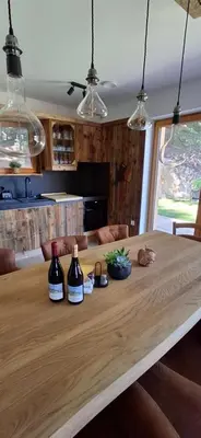 a wooden table with two bottles of wine on it at Savinjski raj in Mozirje