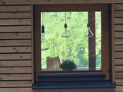 a window with three hanging lights in a room at Savinjski raj in Mozirje