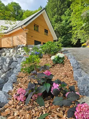 a garden of flowers in front of a house at Savinjski raj in Mozirje