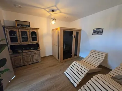 a living room with a cabinet and two chairs at Savinjski raj in Mozirje