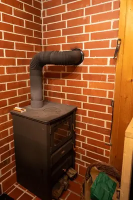 a brick wall with an old stove in a room at Koča na Lazu in Ajdovščina