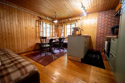 a kitchen with a table and chairs in a room at Koča na Lazu in Ajdovščina