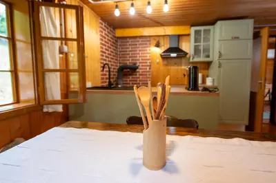 a wooden utensil holder on a table in a kitchen at Koča na Lazu in Ajdovščina