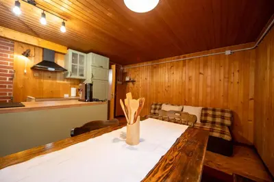 a kitchen with a wooden table in a room at Koča na Lazu in Ajdovščina