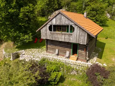 a small wooden house with an orange roof at Koča na Lazu in Ajdovščina