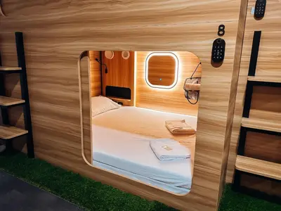 a small room with a bed inside of it at Central Hostel Lesce-Bled in Lesce