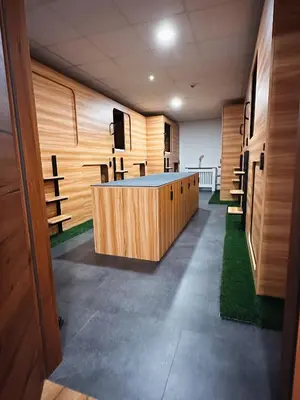 a conference room with wooden walls and a table in the middle at Central Hostel Lesce-Bled in Lesce