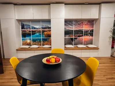 a table and chairs with a bowl of fruit on it at Central Hostel Lesce-Bled in Lesce