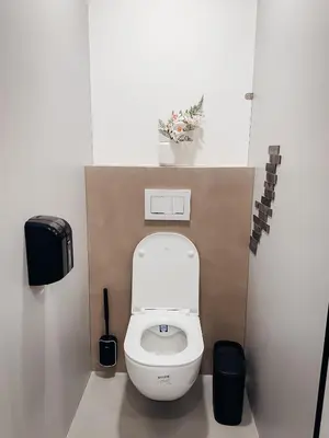 a bathroom with a white toilet in a stall at Central Hostel Lesce-Bled in Lesce