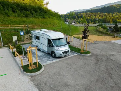 a white truck parked in a parking lot at Barbana Lipizzans Camper Park - Pitches for Campers and Tents in Radovljica