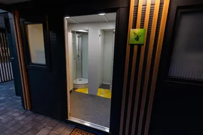 a door to a bathroom with a toilet in it at Barbana Lipizzans Camper Park - Pitches for Campers and Tents in Radovljica