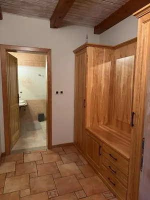 a bathroom with a large wooden cabinet and a shower at Omnia rooms in Sežana