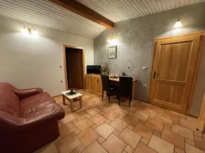 a living room with a couch and a table at Omnia rooms in Sežana