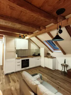 a living room with a couch and a kitchen at Hiša Šturm in Tolmin