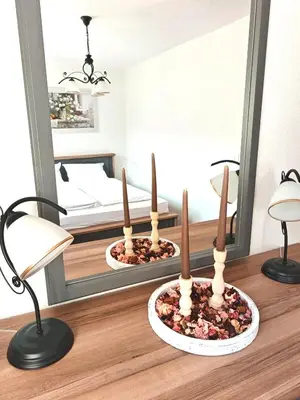 a room with a mirror and two candles on a table at Hiša Šturm in Tolmin