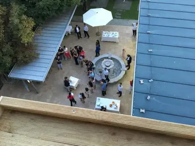 a group of people standing around a table in a courtyard at Lake and Castle view apartment in Bled