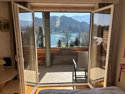 a room with a glass door leading to a balcony at Lake and Castle view apartment in Bled