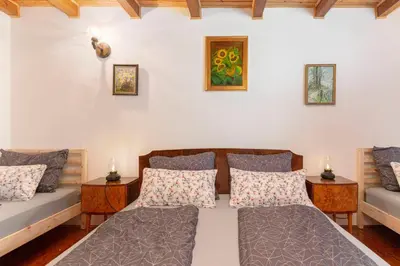 a bedroom with two beds and two tables at Happy Brook Bled in Bled