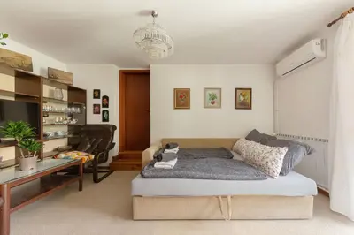a living room with a bed and a desk at Happy Brook Bled in Bled