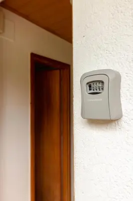 a alarm clock on a wall next to a door at Happy Brook Bled in Bled