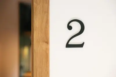 a wooden door with the number on it at Homestead Lukec Studio Apartments - Archery, BBQ, Escape Room, Kayaking in Kostel