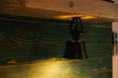 a black bell hanging on a wall at Homestead Lukec Studio Apartments - Archery, BBQ, Escape Room, Kayaking in Kostel